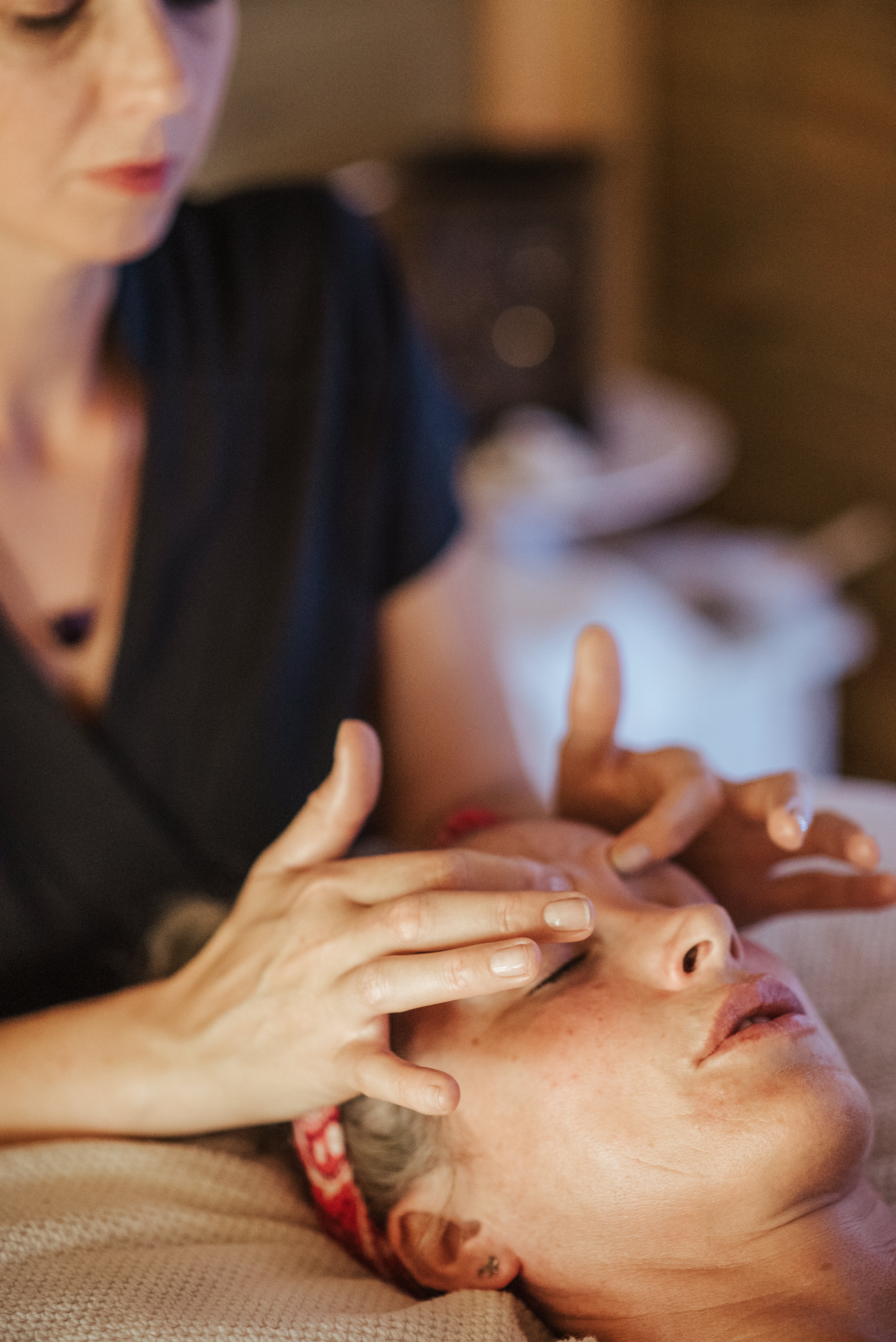 Facial massage being performed on a relaxed client